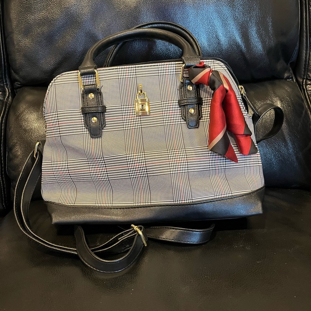 Black, white, red purse shoulder strap and handheld. 3 compartments on inside.